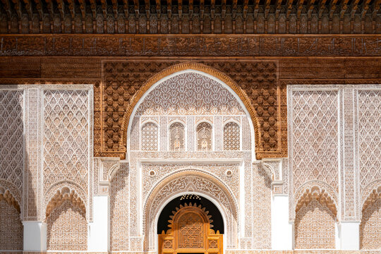 Ben Youssef Madrasa showcasing its detailed Islamic architecture with elaborate carvings stucco wood and mosaic patterns adorning arches walls and doorways highlighting historical design