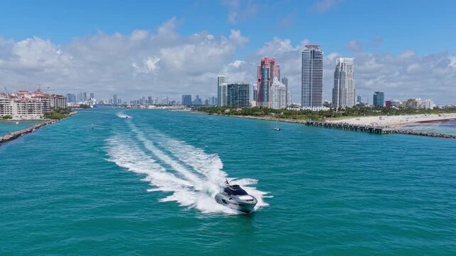 Landscape aerial with Miami skyscraper. Luxury skyscraper in Miami south beach. Motorboat at sea. Landscape of Miami south beach. Yacht at sea. Aerial view on luxury charter yacht. Aerial seascape