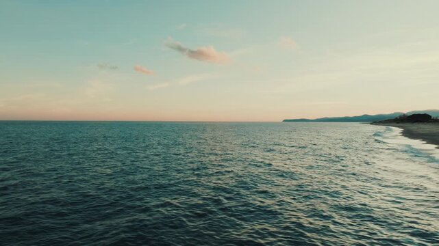 Calm and romantic sea in the evening at sunset representing infinite peace