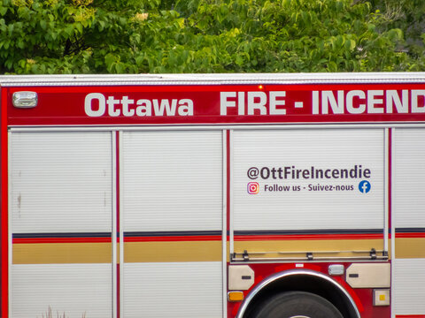 Ottawa, Ontario, Canada. Sep 9, 2026. Close-up side view of Ottawa Fire Services truck exterior with bilingual text and social media handle.