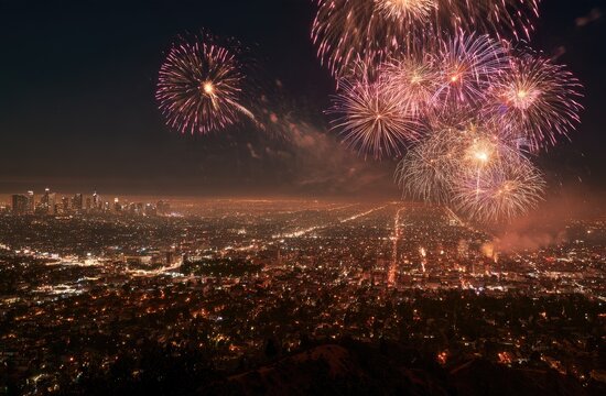 Nighttime cityscape illuminated by vibrant fireworks exploding over buildings