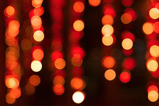Soft-focus bokeh of warm, glowing orange and red lights