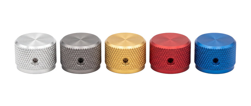 Metal knurled rotary control knobs in multiple colors lined up on black background, anodized aluminum potentiometer volume dials for audio equipment, industrial hardware components and dial interface.
