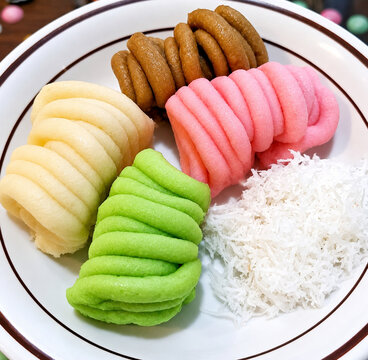 Colorful Getuk Lindri with grated coconut on a white plate