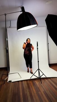 Woman recording video message in professional studio