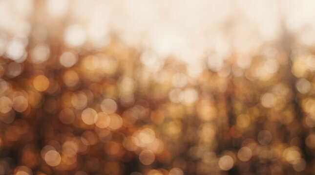 Blurred autumn foliage creates a soft golden light pattern with deep brown and yellow tones.