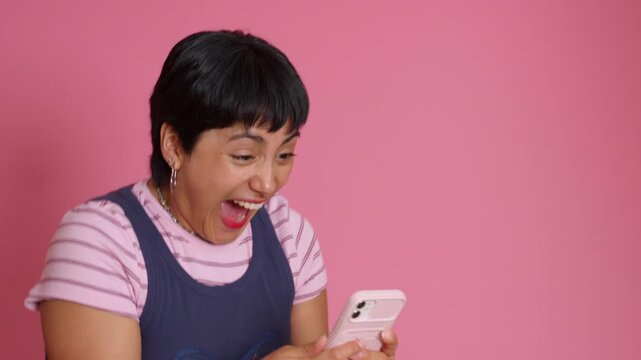 Young woman experiencing a rollercoaster of emotions on her smartphone