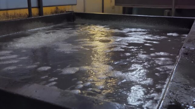 Molten zinc shimmering in a bath