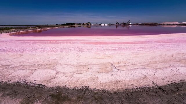 Pink lakes salt marshes, salt mining medieval town of Aigues-Morte, Camargue, France. High quality 4k footage