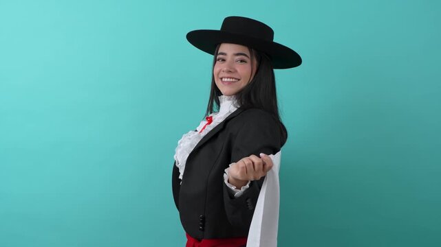 Beautiful woman in traditional chilean huasa costume happily dancing with the national flag