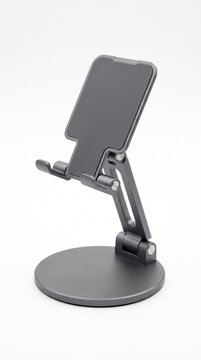 A modern, adjustable phone stand with a sleek dark gray finish, perfect for hands-free viewing on a desk or table