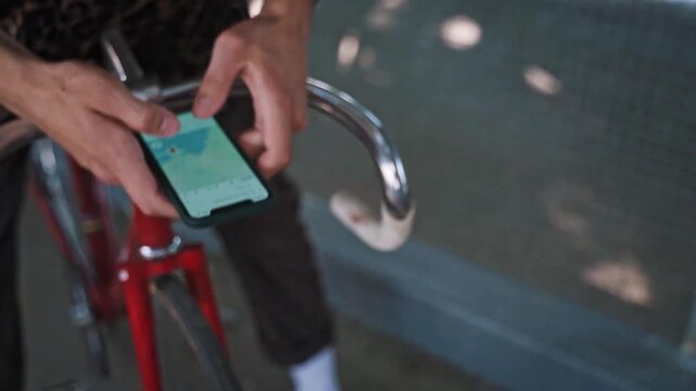 Cyclist using smartphone map for navigation and route planning