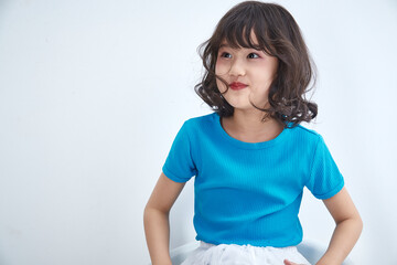 Fototapeta premium Cute Asian little girl with a white background