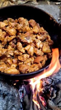 Making traditional "fritada", fried pork in the andes of Ecuador