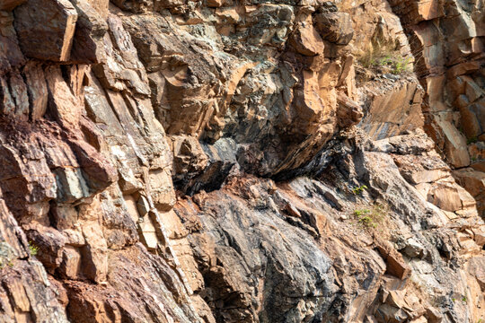 Gaspesie, Quebec, 02 September 2026 : Detail of fractured rock layers and mineral formations on a rugged cliff face