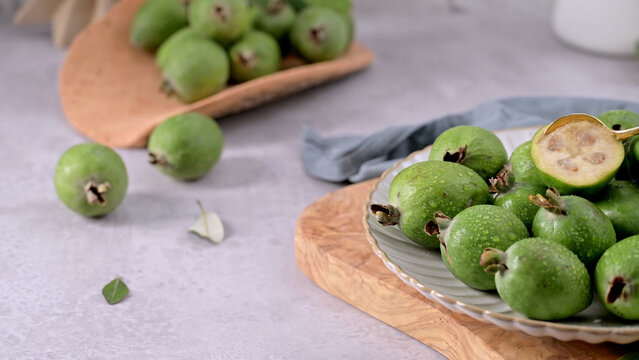 Fresh green feijoa fruits on a wooden board