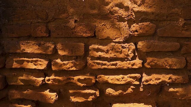 A dilapidated brick arch stained with grime; the play of soft shadows across its masonry and a surface texture weathered by the elements and nature. 4K 