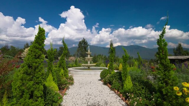 Garden with fountain,gravel path, and mountains