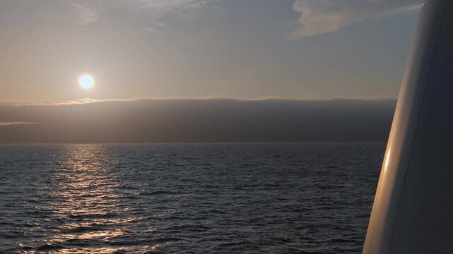 船のデッキから夕陽を望む風景。