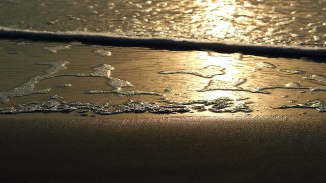 A summer ocean sunset sea background with small waves on the water's surface in lights from sunrise