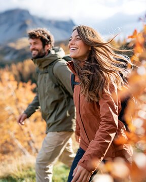Couple smiling and walking outdoors enjoying nature during fall season