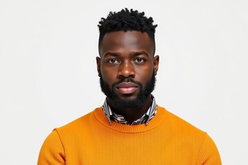 Obraz premium Portrait of a serious man wearing an orange sweater on a white background