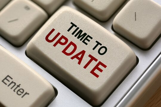 Time to update text highlighted on a computer keyboard key under bright office lighting.