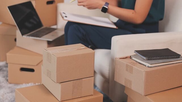Portrait of Starting small businesses SME owners, two Asian woman check online orders Selling products working with boxs freelance work at home office, sme business online small medium enterprise