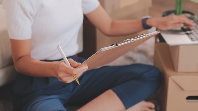 Portrait of Starting small businesses SME owners, two Asian woman check online orders Selling products working with boxs freelance work at home office, sme business online small medium enterprise