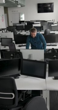 One Mature Male IT Professional in Modern Office working with Technology, Working Late in Empty Office