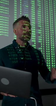 Mature Male Technology Expert Presenting Data Analysis on Screen, using Laptop