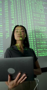 Confident Female Professional Analyzing Data on Projection screen, using Laptop
