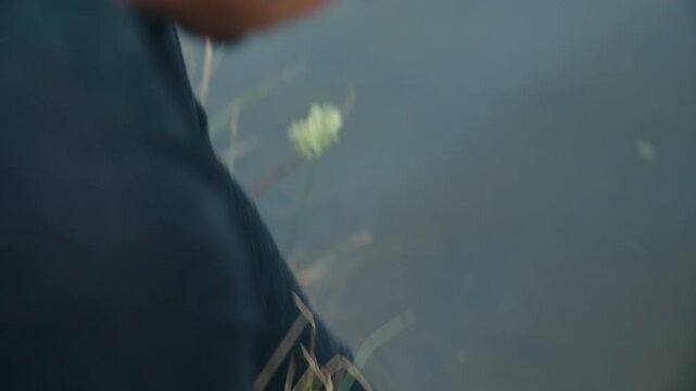 The camera shifts focus from a freshly cleaned brown trout in the foreground to the angler&rsquo;s face above, emphasizing concentration, manual work, and the quiet intensity of outdoor fish preparation.