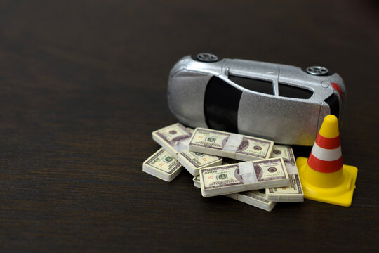 Car Accident Financial Loss Concept with Damaged Vehicle, Cash and Traffic Cone