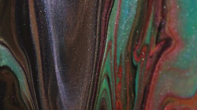 Dirty dye leak. Art liquid. Glitter acrylic flow dissolving defocused paint shimmering. Black red green abstract color background.