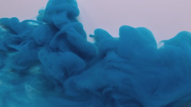 Smoke ink. Dye spread. Blue puff spray cloud flow spiral spill liquid pigment white background. Abstract blur color fog explosion.