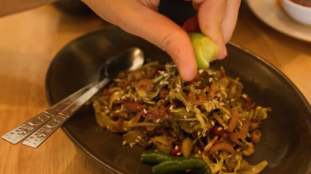 Squeezing Fresh Lime over Burmese Fermented Tea Leaf Salad