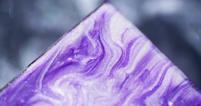 Color paint. Acrylic triangle. Defocused purple marble mix glitter texture flow on abstract art sparkling vibrant background.