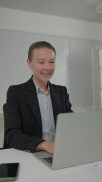 Businesswoman experiencing emotions while working on her laptop