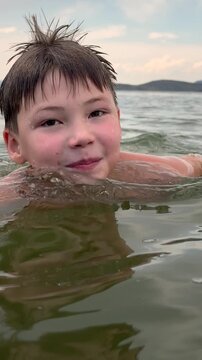 Smiling Boy Swimming and Dipping Underwater in Slow Motion