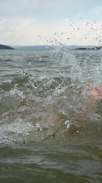 Girl Dipping Underwater and Splashing Playfully