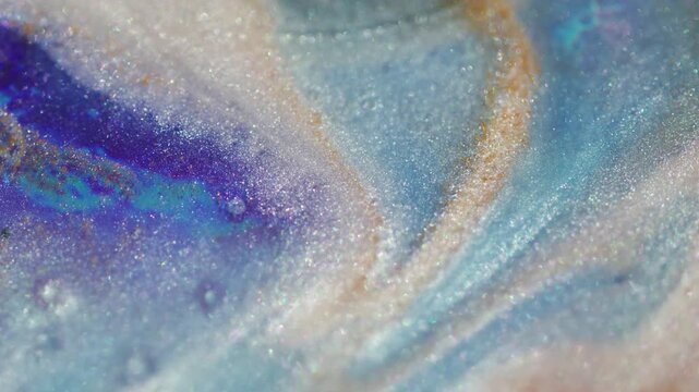 Sparkling flow. Defocused ink blend. Blue purple pigment fluid swirling on glowing color texture with white particles on abstract background.