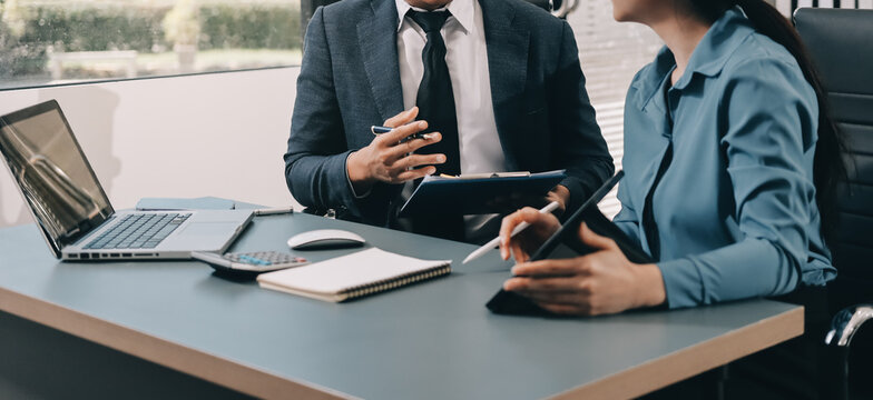 Business professional analyzing financial data on digital tablet dashboard with calculator and laptop, representing accounting software, ERP system integration, performance monitoring.