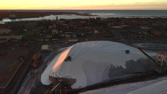 Excavators load raw material onto conveyors for shipping port hedland australia