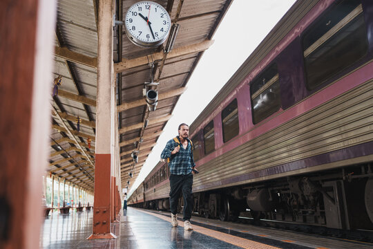 Traveler man hurrying on train station platform
