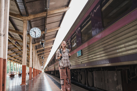 Woman backpacker waiting on train station platform