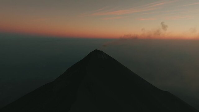 Fuego Volcano eruption drone footage at dawn, dramatic ash cloud and colorful sky