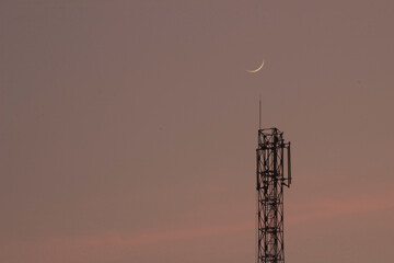 crescent moon above a communication tower © Tawfeq