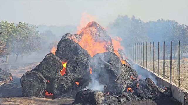 Fire in a village. Hay bales.