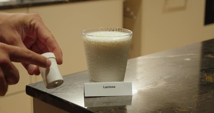 Lactase Tablets for Lactose Intolerance With Glass of Milk